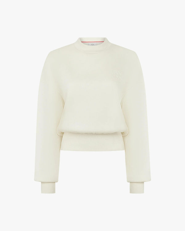 Elegant cream sweatshirt with debossing crafted from buttery-soft lyocell fleece, featuring a relaxed fit and refined details.
