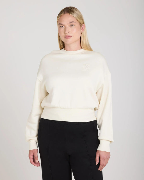 Cream sweatshirt with debossed detailing in lyocell fleece worn by model