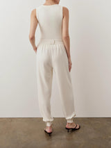 Back view of Emello's cream balloon popper trousers showcasing relaxed fit and tapered hem with adjustable poppers.