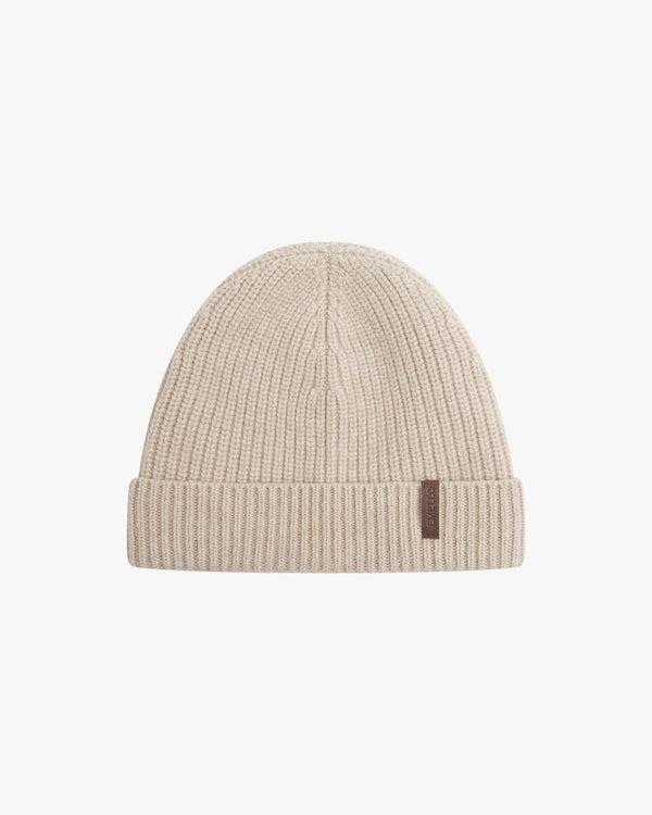 Neutral beige beanie in Merino Wool-Cashmere with a fold-over cuff and soft leather label.