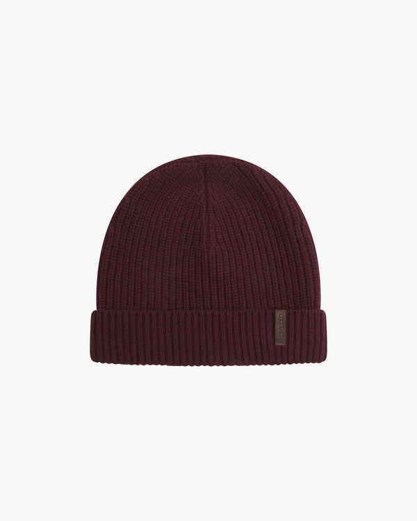 Merino Wool Cashmere Beanie in Fig with fold-over cuff and soft leather label, showcasing refined and tactile elegance.