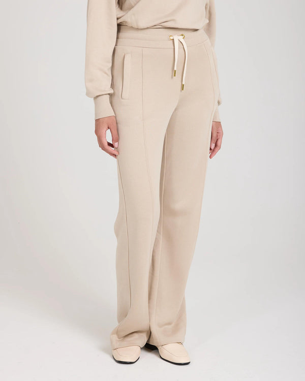 Beige wide leg lyocell joggers featuring gold accents and a relaxed fit, made in Portugal.