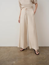 Cream Bouclé Wide Leg Trousers, featuring ribbed waistband and pointelle side panels.