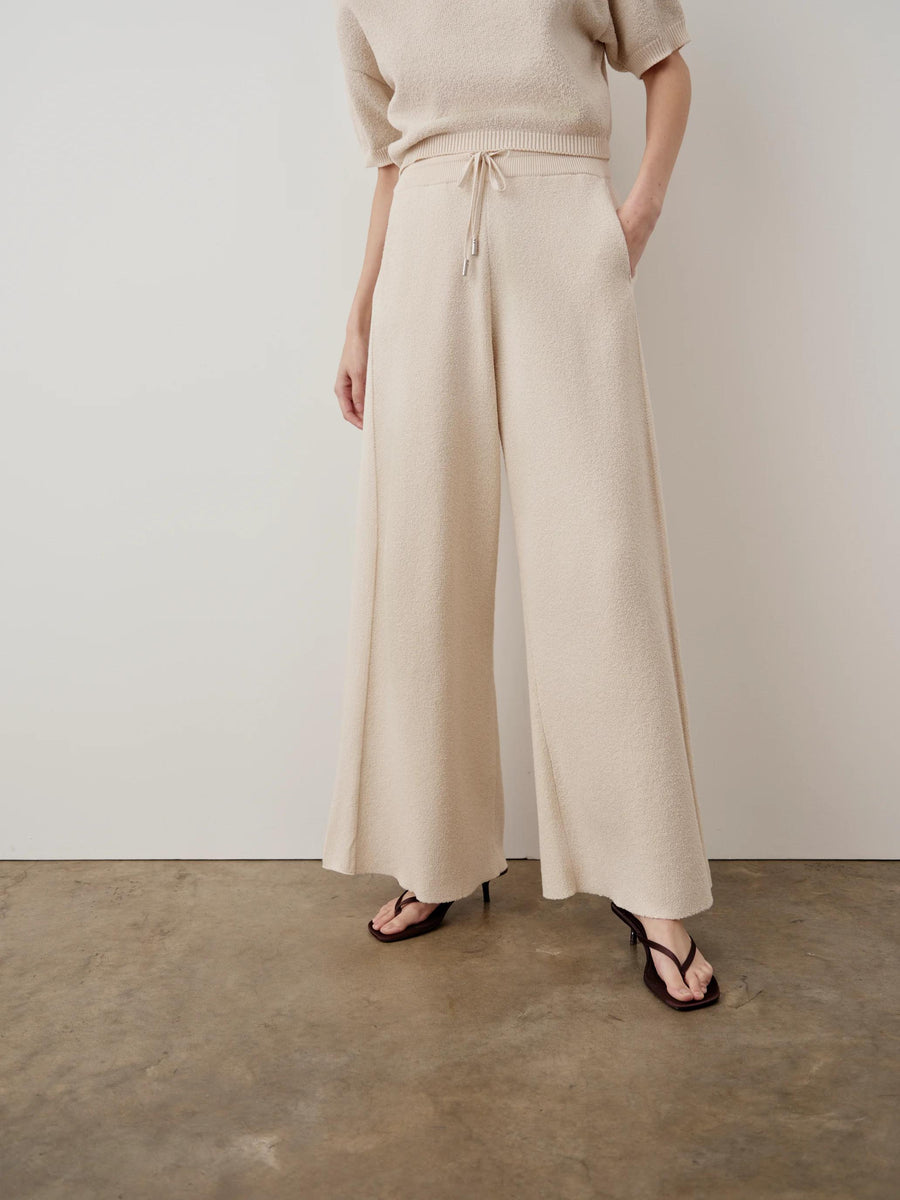 Cream Bouclé Wide Leg Trousers, featuring ribbed waistband and pointelle side panels.