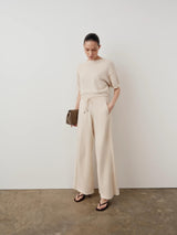 Emello Bouclé Wide Leg Trousers in cream, showcased with a harmonious drape.