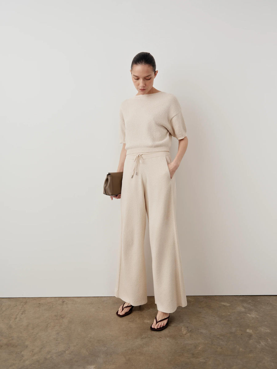 Emello Bouclé Wide Leg Trousers in cream, showcased with a harmonious drape.