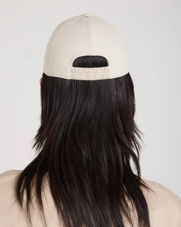 Back view of the Emello Beige Cap with elasticated back and brushed cotton texture.
