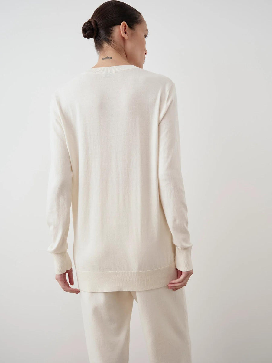 Back view of a cream cotton-cashmere cardigan showcasing elegant, refined knit texture.