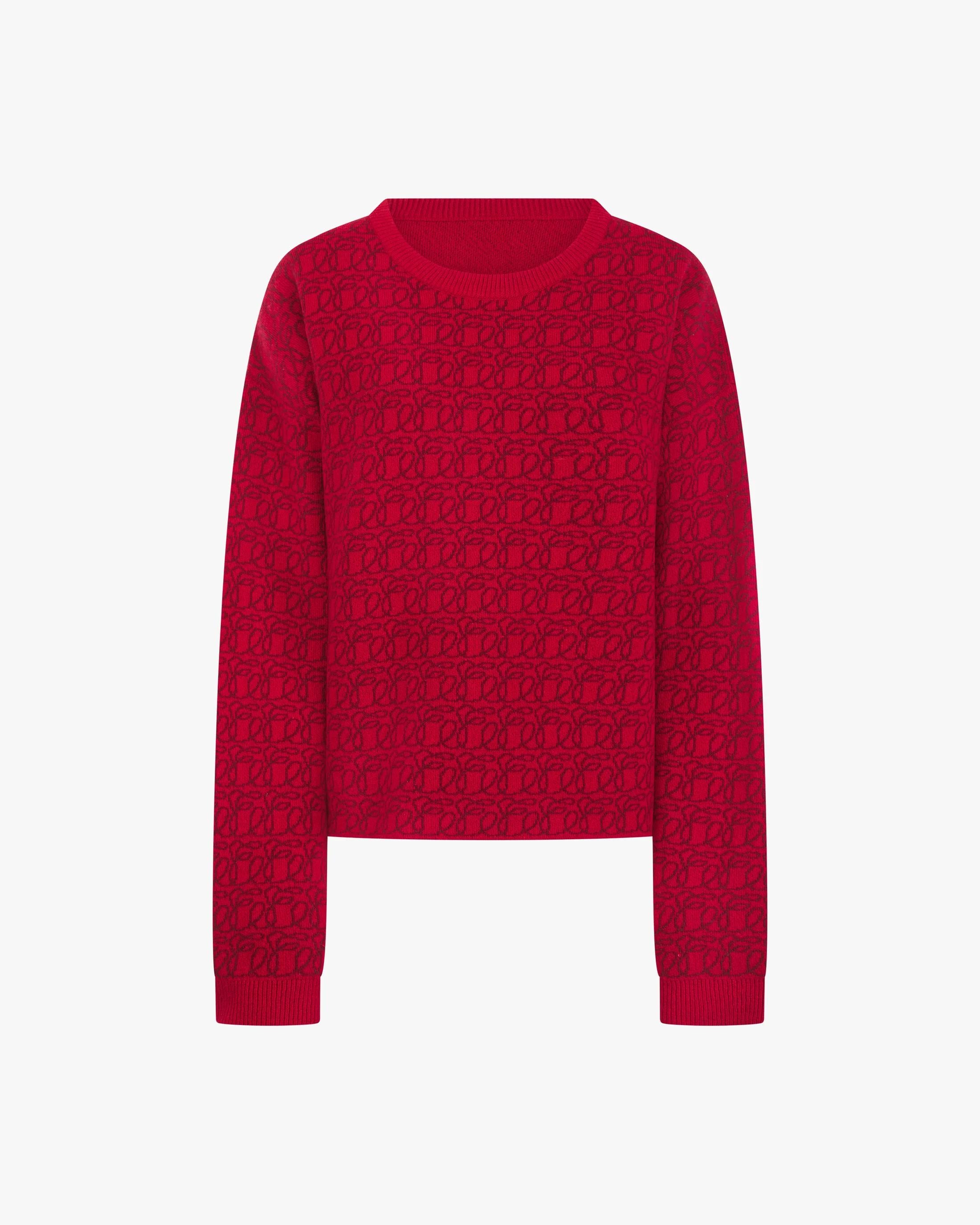 Reversible red jacquard cashmere sweater from Emello, showcasing a luxurious tactile pattern.