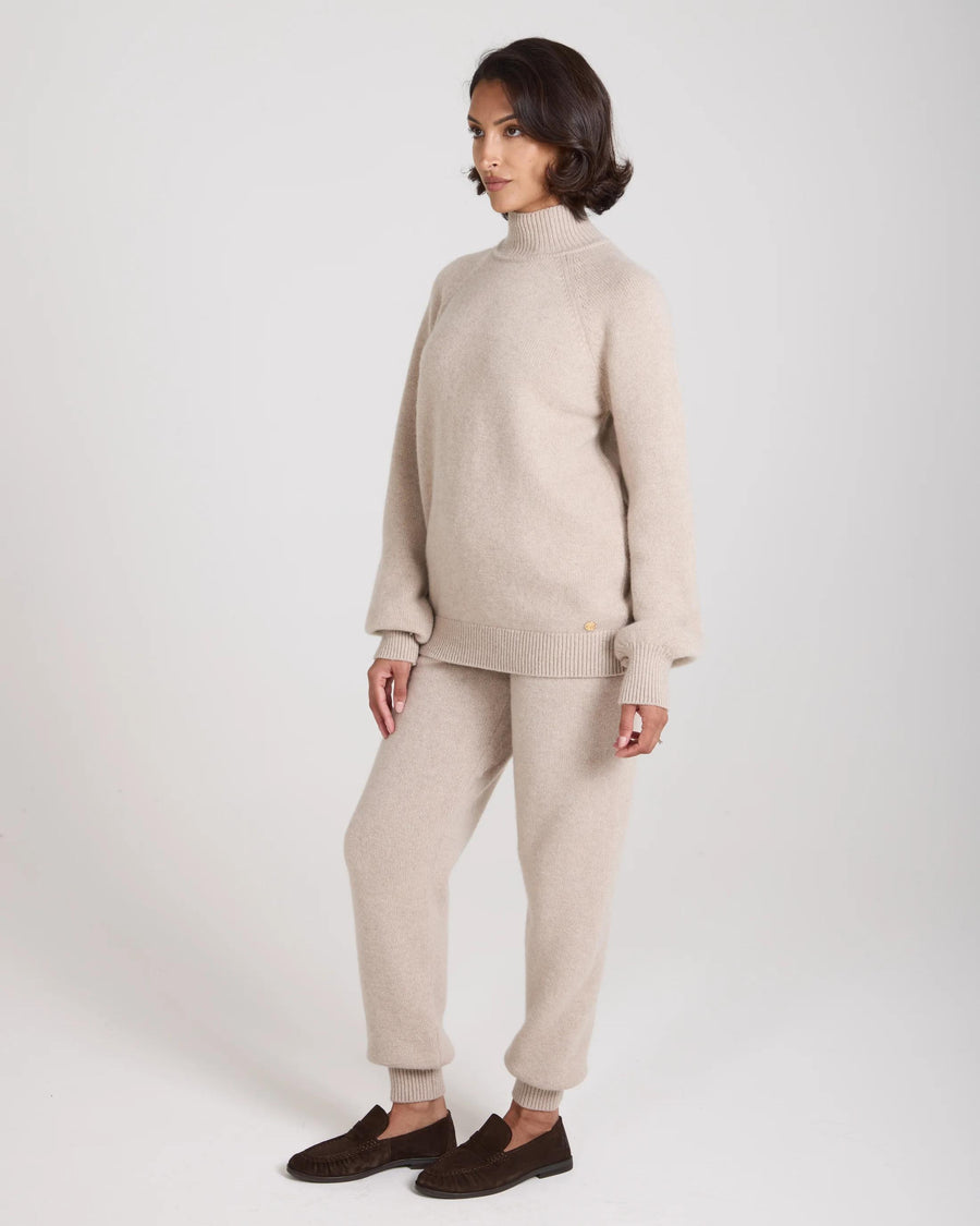 Emello Kasima Cashmere Blend Knit Sweater in beige, featuring a relaxed fit with a rib funnel neck and long sleeves.