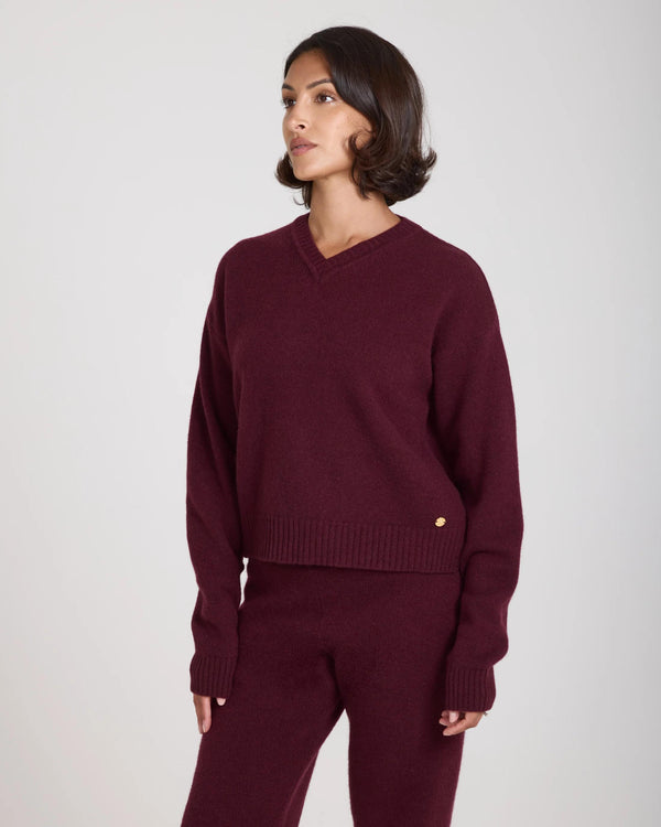 Emello Kasima Cashmere Blend V Neck Sweater in rich fig, worn by model, showcasing relaxed fit with deep ribbed details.