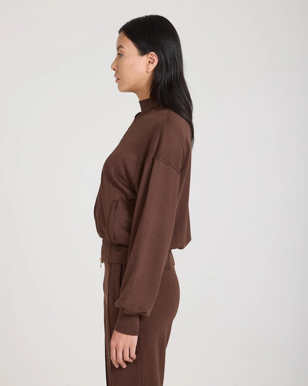 Model wearing the Mello Lyocell Fleece Zip-Through Jacket in Chocolate, side view.