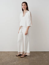 White contrast collar knit polo top with Italian-spun organic cotton and visous panels, styled with matching trousers.
