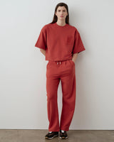 Red short sleeve pocket sweatshirt, relaxed fit, styled with matching trousers.
