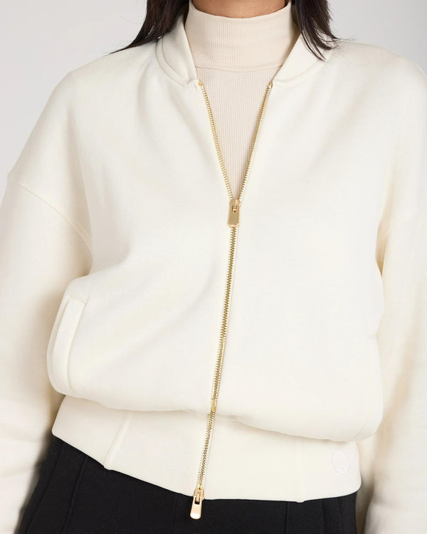 Cream zip-through jacket in buttery-soft lyocell, featuring gold hardware, relaxed fit.