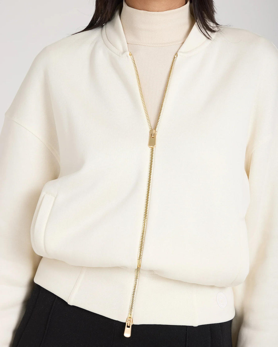 Cream zip-through jacket in buttery-soft lyocell, featuring gold hardware, relaxed fit.