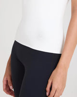 Cream lyocell jersey top with raised embroidery and a slim fit, showcased on a model.