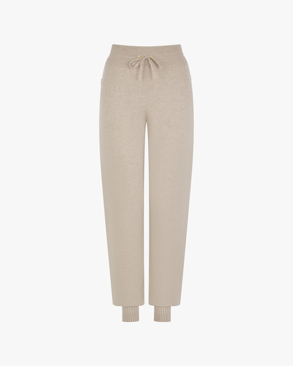 Beige cuffed trousers in merino wool-cashmere blend with gold hardware and zipped pockets.