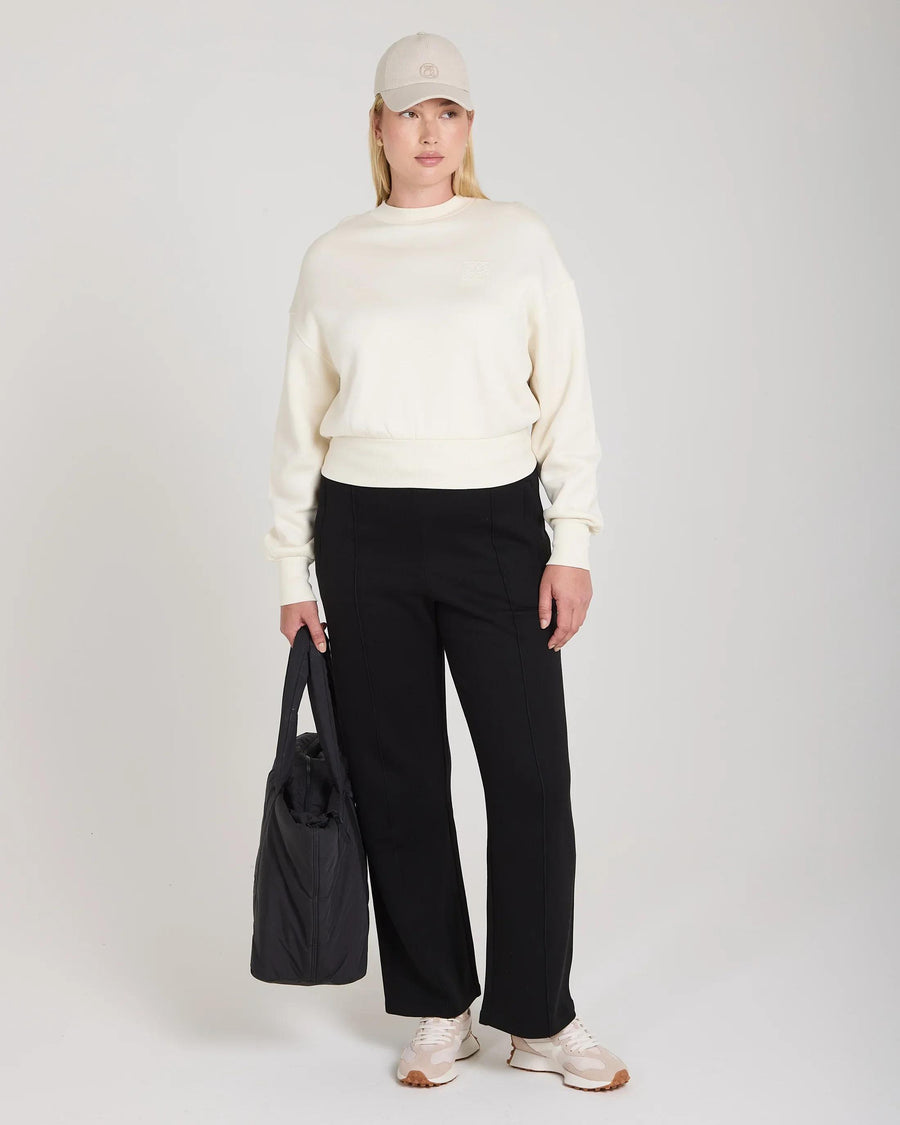 Cream sweatshirt with debossing in buttery-soft lyocell worn by a model standing gracefully.