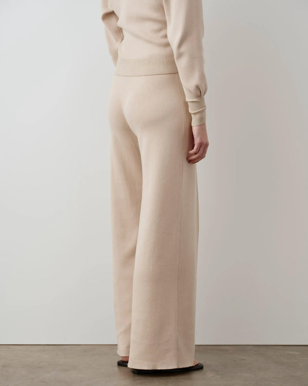 Back view of the Double Waistband Knitted Trousers in neutral, showcasing the wide-leg silhouette.