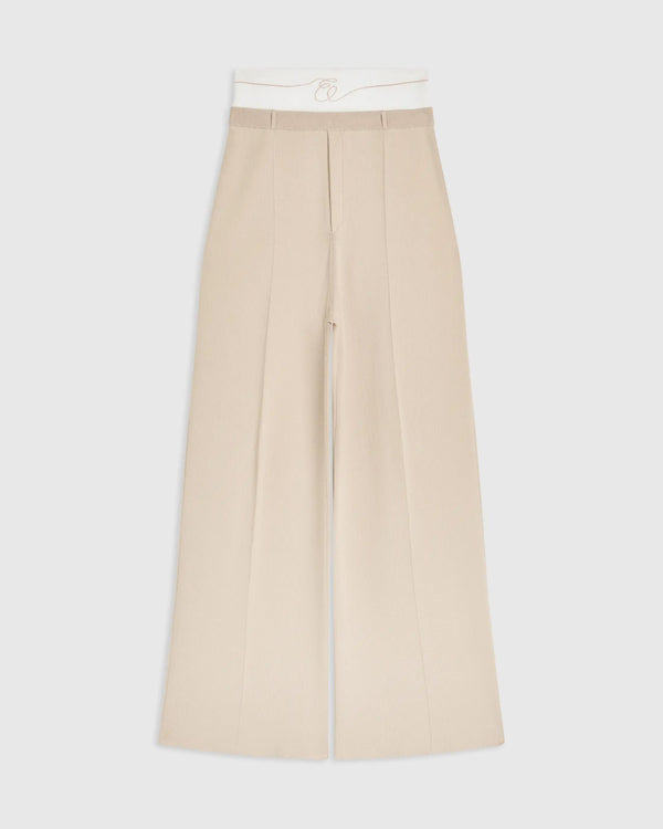 Double waistband knitted trousers in neutral tone featuring a wide-leg silhouette.