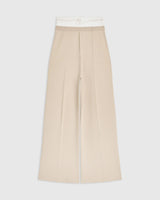 Double waistband knitted trousers in neutral tone featuring a wide-leg silhouette.