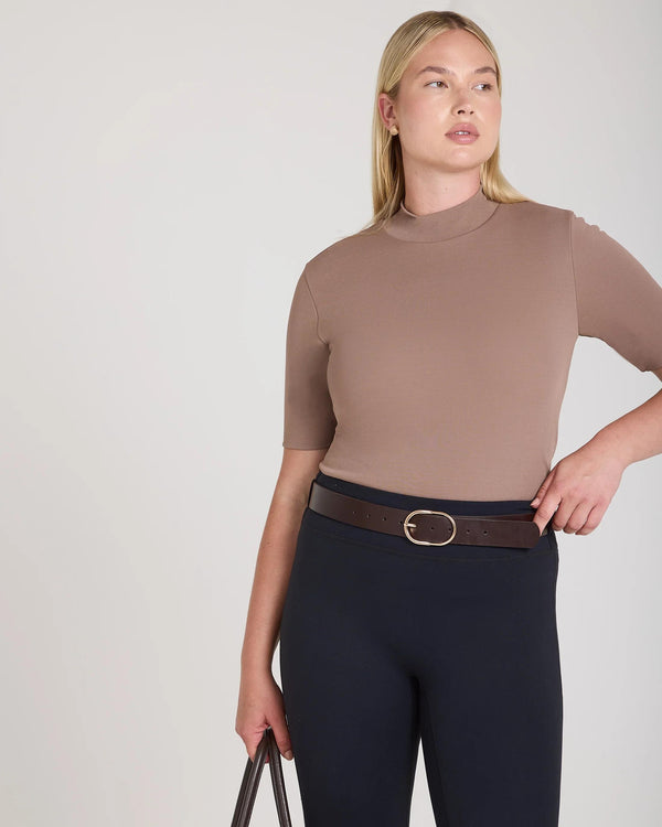 Taupe double layer high neck top in viscose, worn with dark trousers.