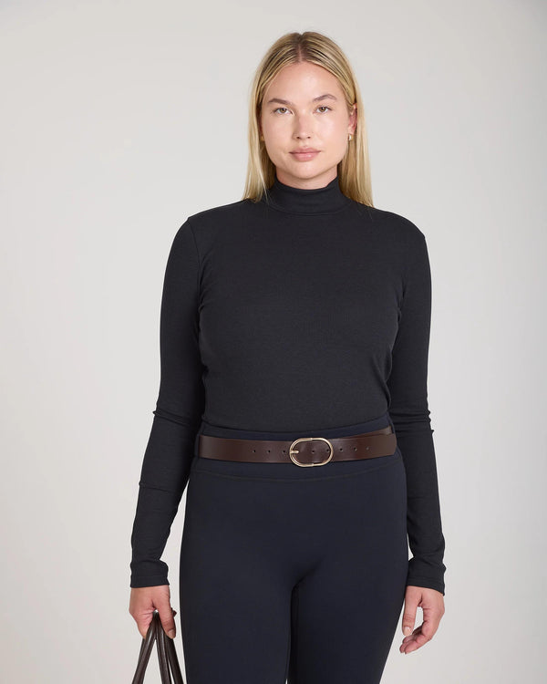 Emello Forma Ribbed Lyocell-Cotton Blend Turtleneck Top in Black, featuring a high shaped collar and ribbed texture.