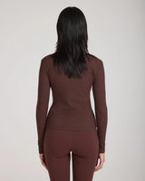 Back view of the Forma Ribbed Lyocell-Cotton Blend Turtleneck Top in Chocolate, showcasing its slim fit and ribbed texture.