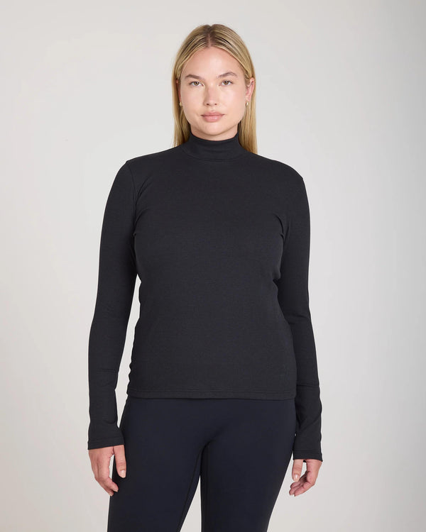Emello Forma Ribbed Lyocell-Cotton Blend Turtleneck Top in Black, showcasing long sleeves and a high collar.