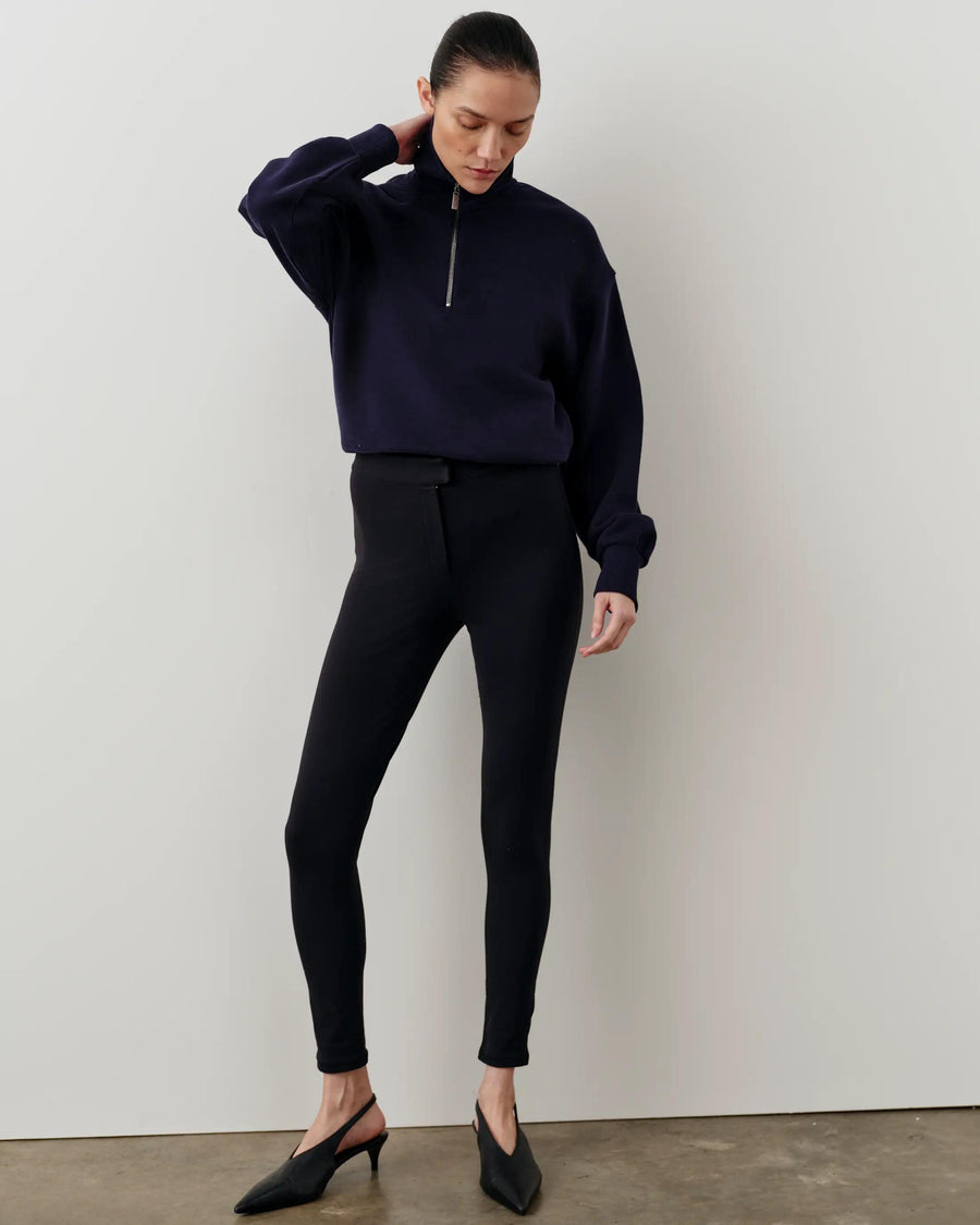 Model wearing Emello's navy half-zip funnel-neck sweatshirt with relaxed blouson fit.