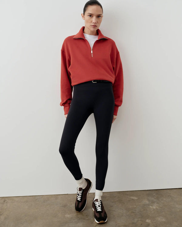 Red half-zip funnel-neck sweatshirt with a blouson silhouette, paired with black leggings.