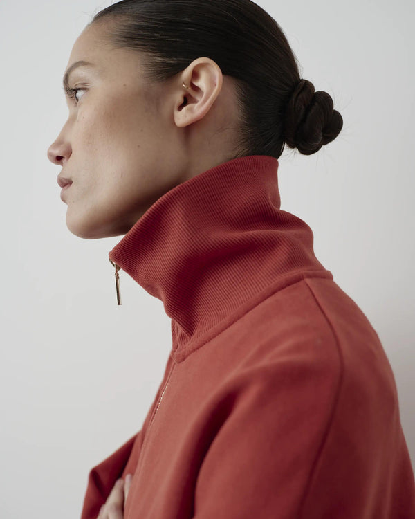 Half-Zip Funnel-Neck Sweatshirt in rust red, showcasing sculpted neckline and brushed metal zip detail.