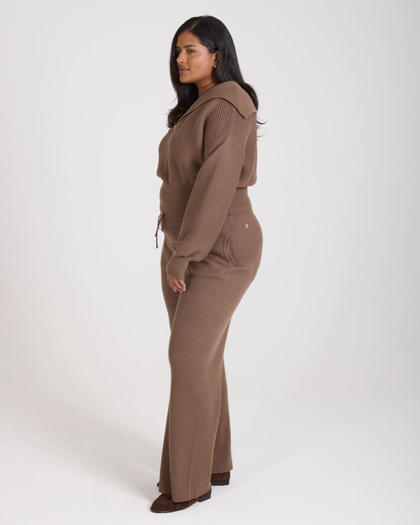 Emello Sorella Ribbed Half Zip Jumper in Taupe, a relaxed fit cotton-cashmere blend, modeled in a poised side stance.