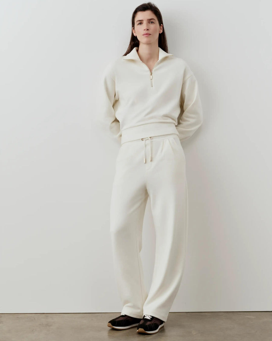 Emello Half-Zip Funnel-Neck Sweatshirt in cream, styled with matching trousers, exhibiting a relaxed, elegant posture.