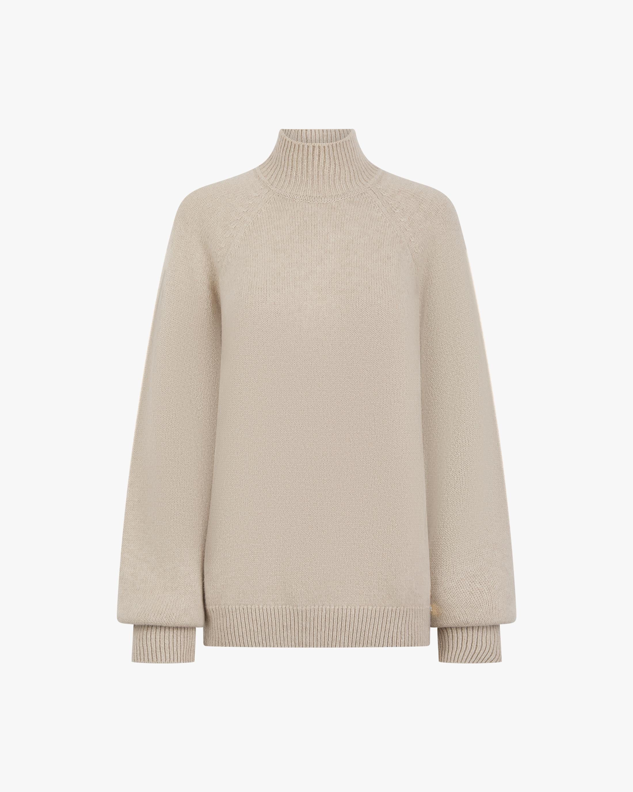Elegant high-neck beige sweater crafted in fine merino wool and cashmere.