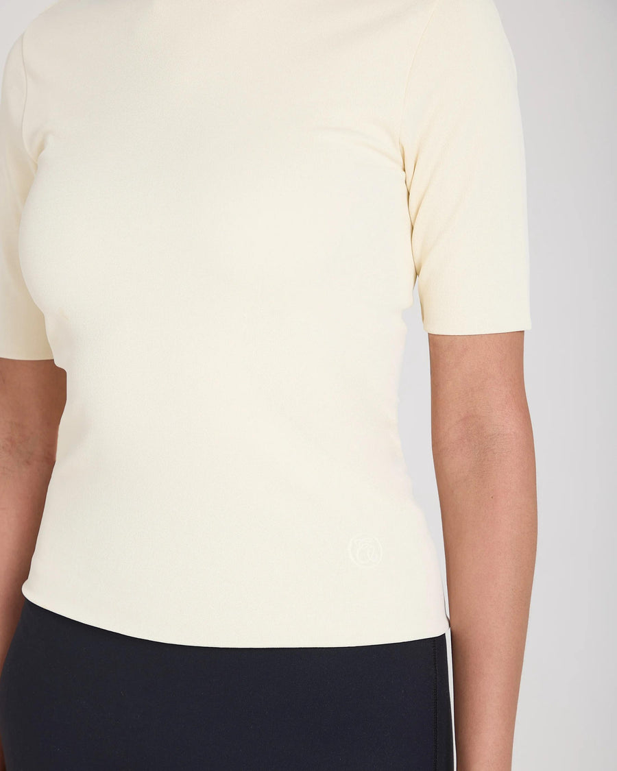 Cream double-layer high neck top by Emello in a refined viscose blend, exuding tactile elegance.