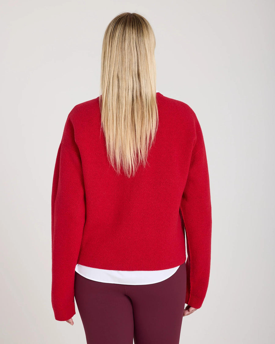 Back view of the Reversible Jacquard Cashmere Sweater in red, showcasing tactile elegance.