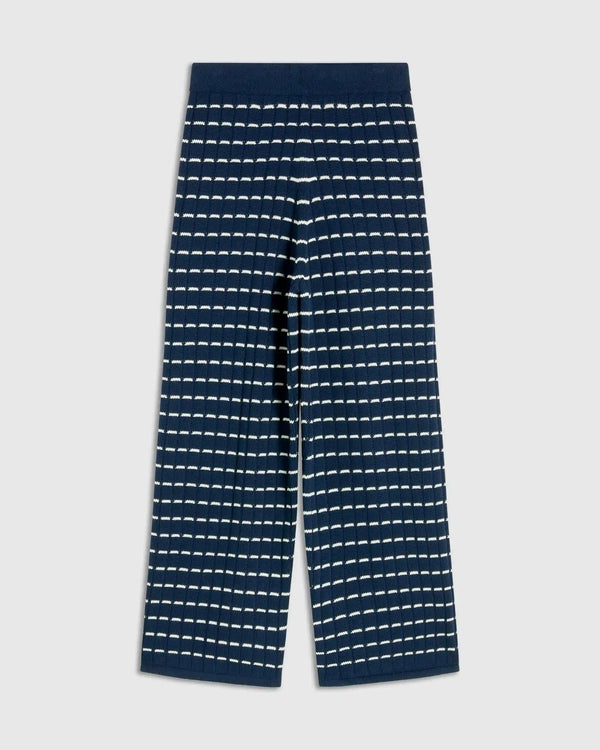 Navy blue pants with white stripe pattern on a light gray background