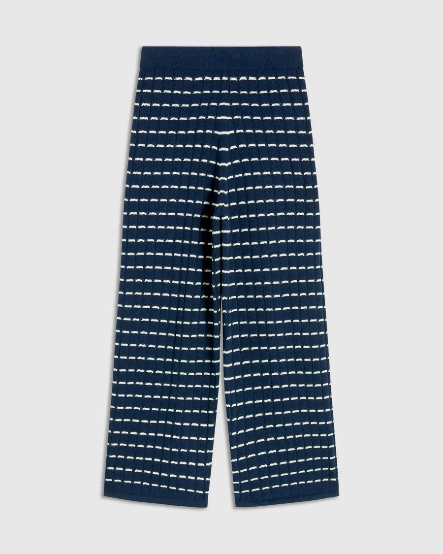 Navy blue pants with white stripe pattern on a light gray background