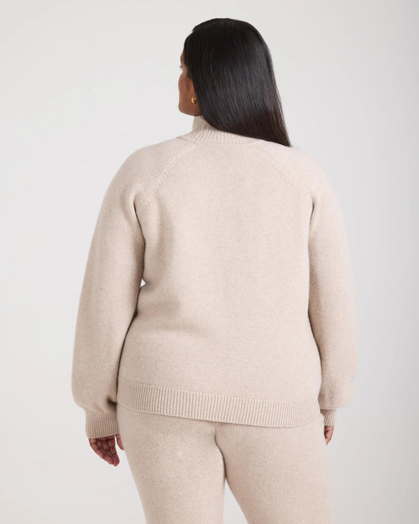 Back view of model wearing the Emello Kasima Cashmere Blend Knit Sweater in Oatmeal Beige.