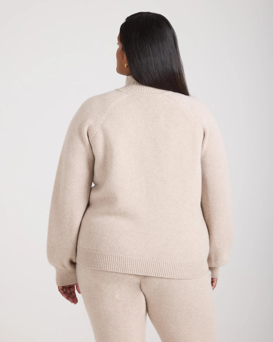 Back view of model wearing the Emello Kasima Cashmere Blend Knit Sweater in Oatmeal Beige.