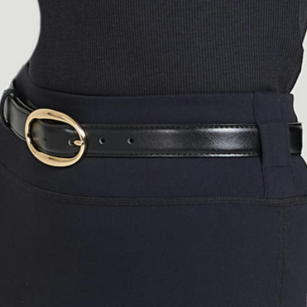 Black leather belt with sculptural gold buckle on tailored waistband