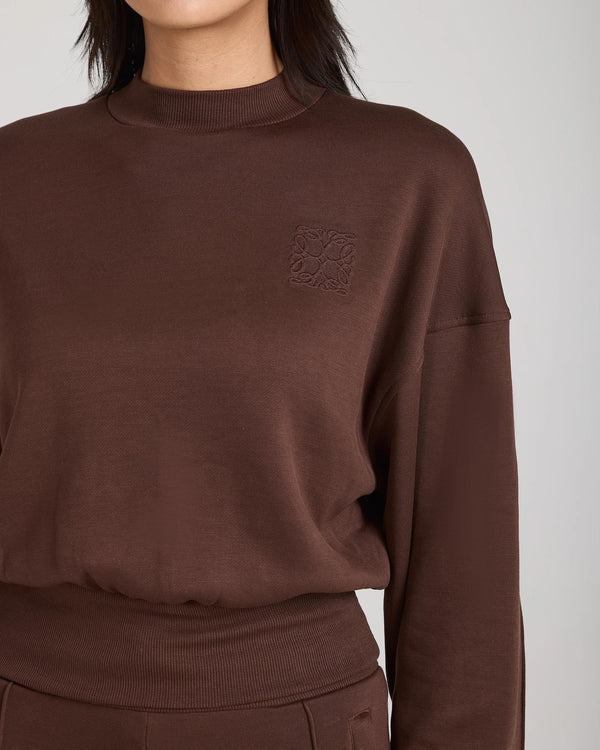 Emello chocolate brown lyocell fleece sweatshirt with embossed logo badge and relaxed fit.