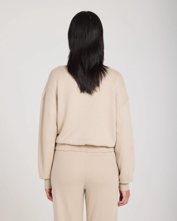 Back view of Mello Lyocell Fleece Zip-Through Jacket in beige, showcasing a relaxed silhouette and refined design.