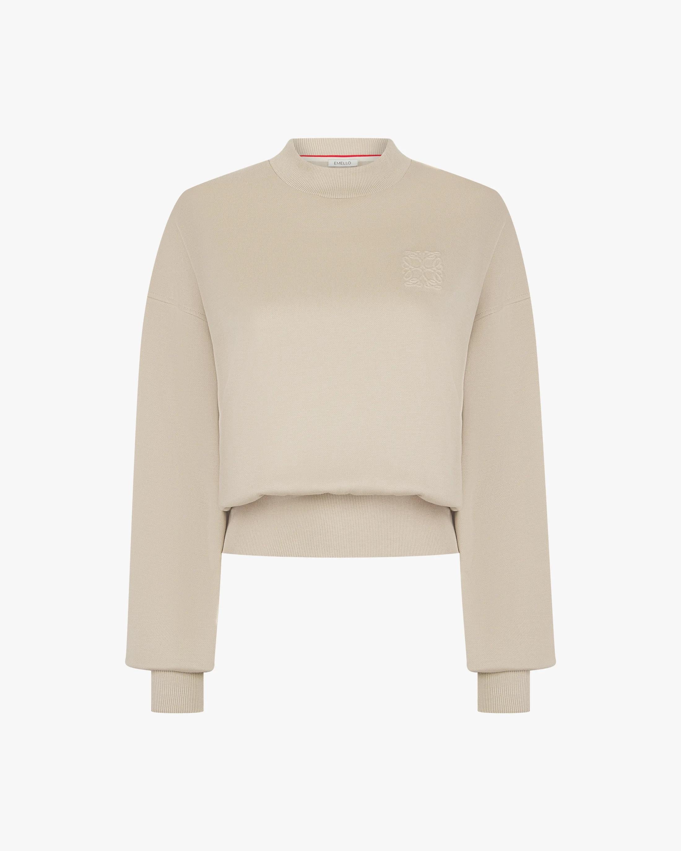 Beige lyocell sweatshirt with debossing on the chest, featuring ribbed cuffs and crew neck.