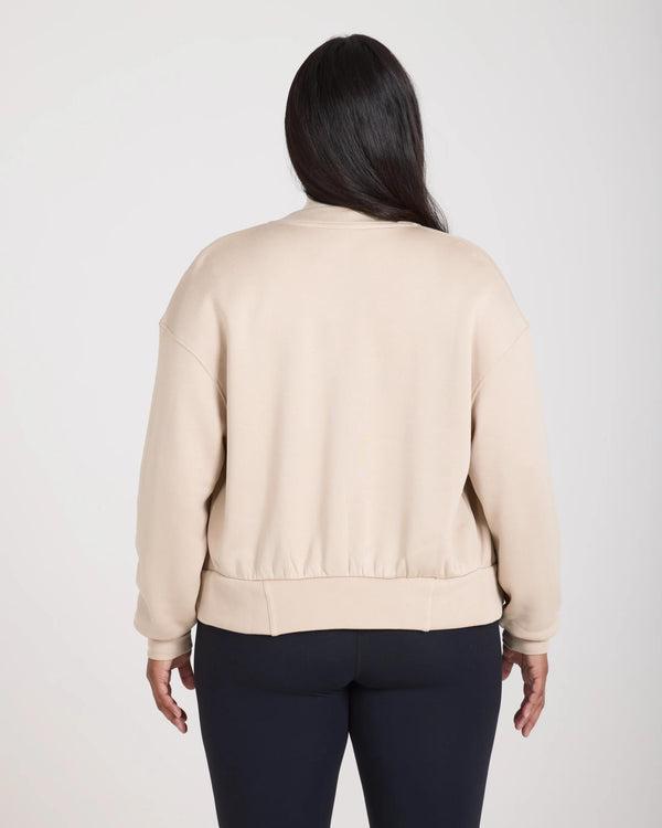 Back view of the Mello Lyocell Fleece Zip-Through Jacket in Beige, showcasing the relaxed fit and ribbed detailing.