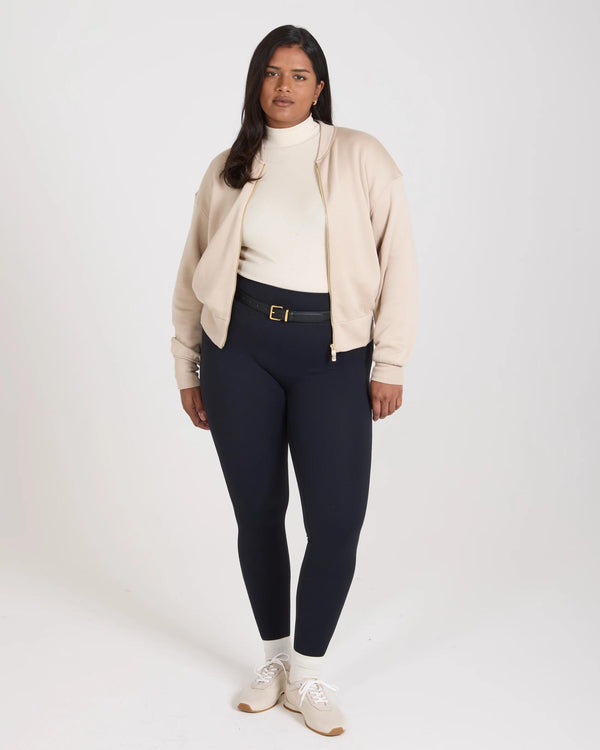 Model wearing a beige lyocell fleece zip-through jacket with relaxed fit and stand collar.