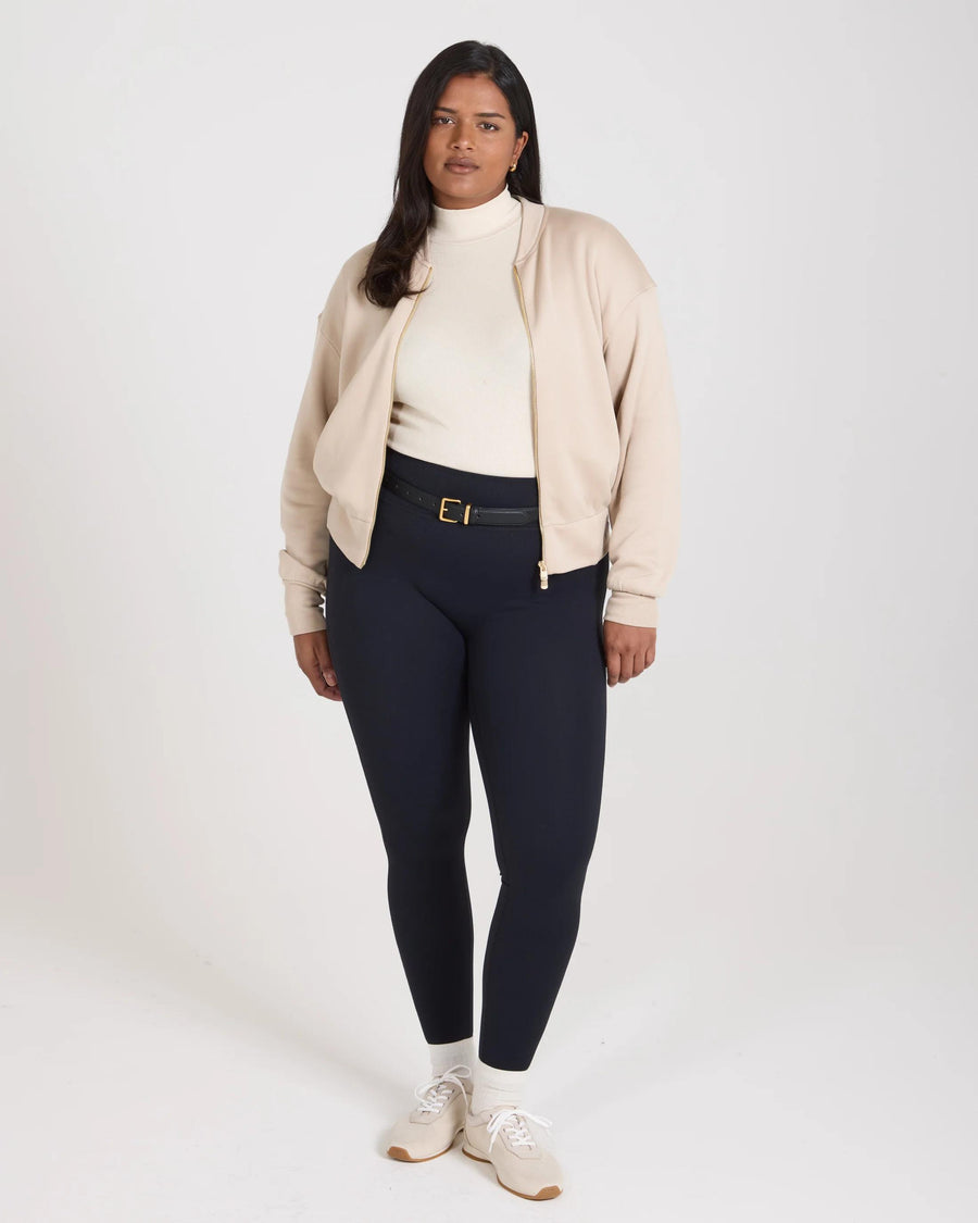 Model wearing a beige lyocell fleece zip-through jacket with relaxed fit and stand collar.