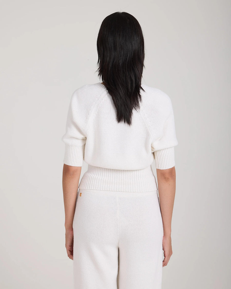 Back view of cream puff sleeve sweater in merino wool cashmere blend, worn by a model.